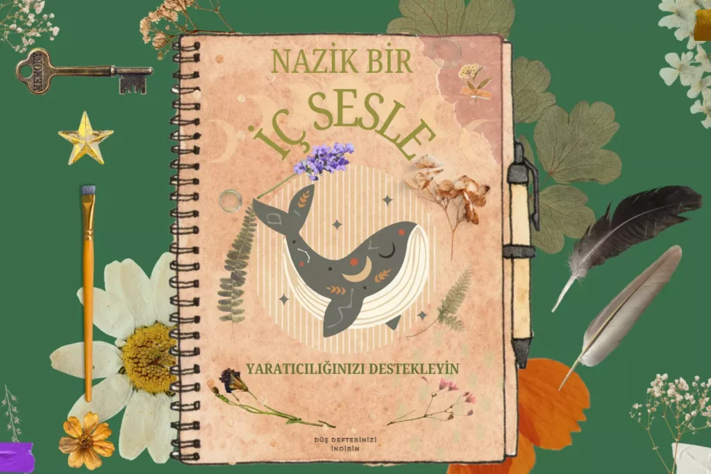 Üstünde balina olan bir defterin kenarında kurutulmuş çiçekler ve kuş tüyleri.