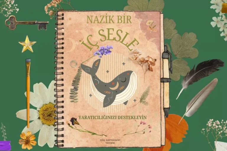 Üstünde balina olan bir defterin kenarında kurutulmuş çiçekler ve kuş tüyleri.